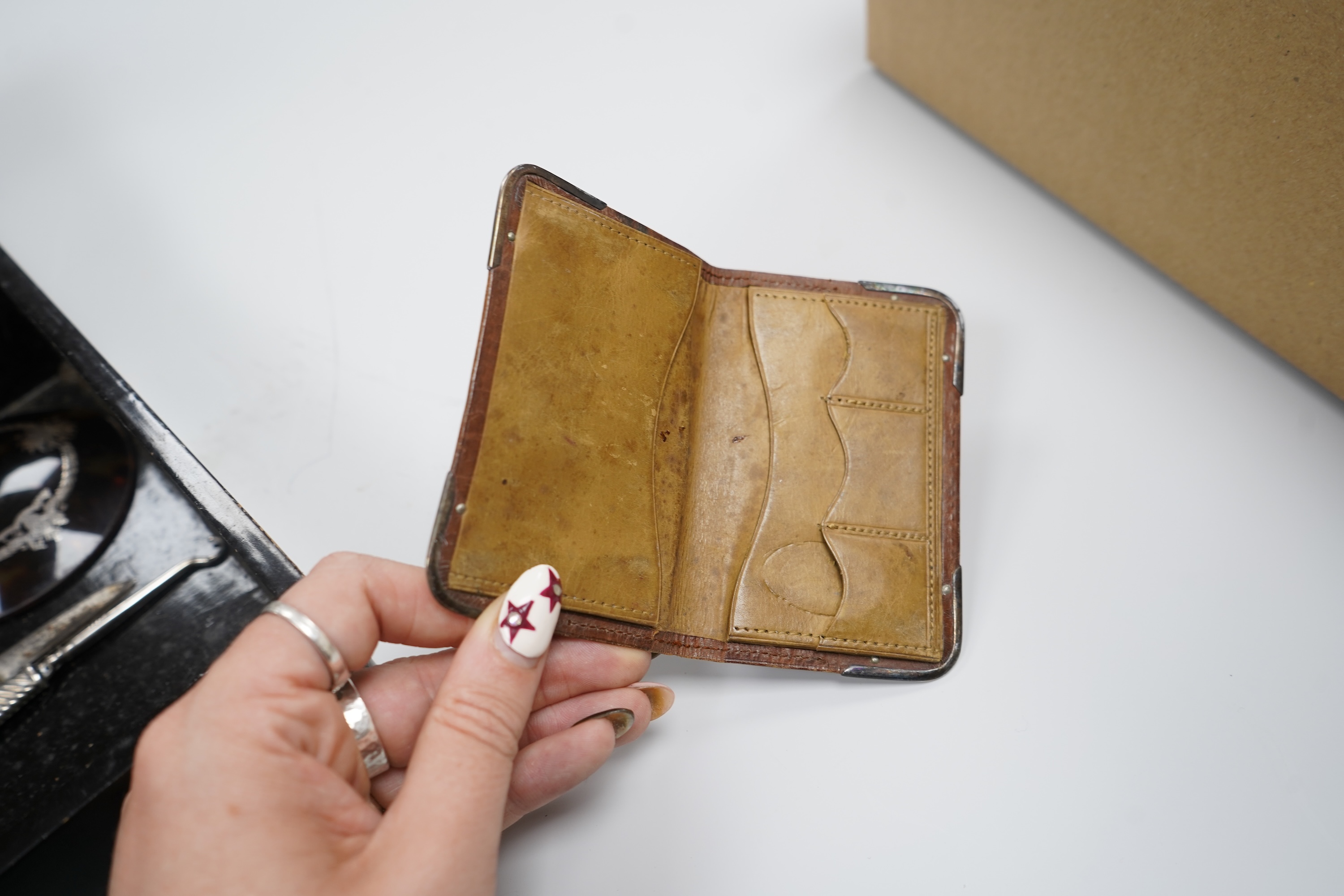 A group of costume jewellery and collector's items in a Japanese lacquer box
